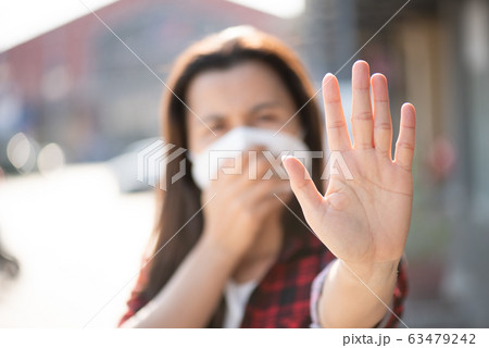 Close up of woman wearing protective face mask 63479242