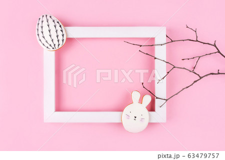 Easter egg and bunny cookies on pink background. 63479757