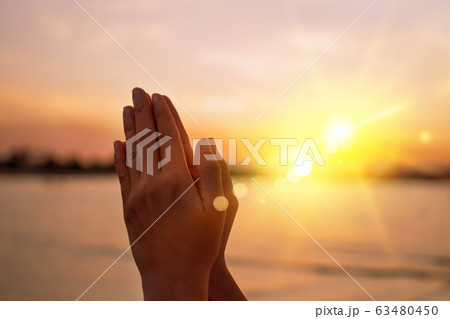 Woman hands place together like praying in front Woman hands place together like praying in front 63480450
