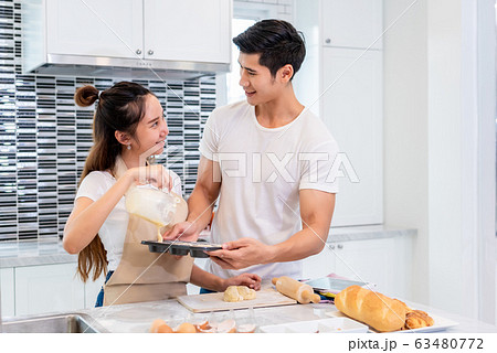 Happy Asian couples cooking and baking cake Happy Asian couples cooking and baking cake 63480772