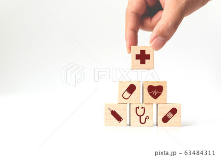 Hand arranging wood block stacking with icon healthcare medical, Insurance for your health concept Hand arranging wood block stacking with icon healthcare medical, Insurance for your health concept 63484311