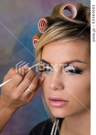 Creating stylish look of housewife in curlers 63484683