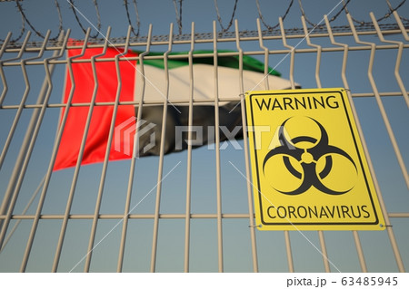 Coronavirus biohazard sign on the fence against the UAE flag. Medical quarantine, conceptual 3D rendering Coronavirus biohazard sign on the fence against the UAE flag. Medical quarantine, conceptual 3D rendering 63485945