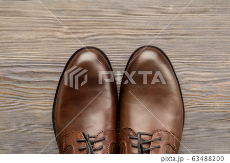 Fashionable men's classic brown shoes on a wooden Fashionable men's classic brown shoes on a wooden 63488200