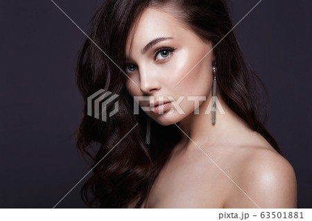 Beautiful young brunette woman with healthy curly Beautiful young brunette woman with healthy curly 63501881