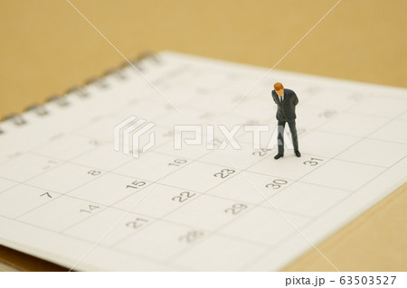Miniature people businessmen standing on white 63503527