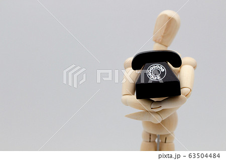 電話を抱えるデッサン人形　電話を待つ人イメージ 63504484