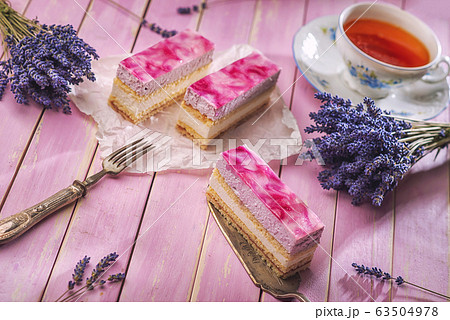 lavender cake served on pink background with flowers and cup of tea, vintage background with cake lavender cake served on pink background with flowers and cup of tea, vintage background with cake 63504978