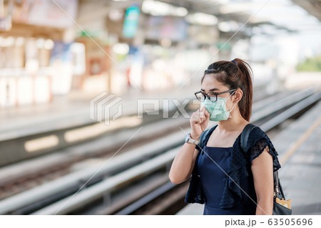 young Asian woman wearing Surgical face mask 63505696