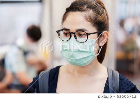 young Asian woman wearing Surgical face mask young Asian woman wearing Surgical face mask 63505712