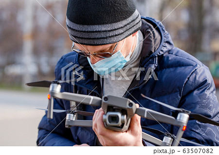 Surveyor in a protective mask prepares a 63507082