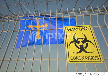 Coronavirus warning sign on the barbed wire fence near flag of Asturias, an autonomous community in Spain. COVID-19 quarantine related 3D rendering Coronavirus warning sign on the barbed wire fence near flag of Asturias, an autonomous community in Spain. COVID-19 quarantine related 3D rendering 63507897