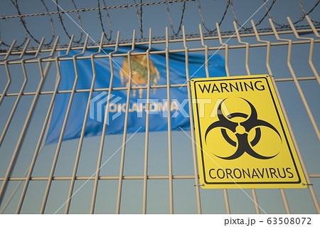 Biohazard coronavirus sign on the barbed wire fence near flag of Oklahoma. COVID-19 quarantine related 3D rendering 63508072