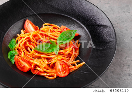 Spaghetti with tomato sauce, basil leaves, cherry tomatoes Spaghetti with tomato sauce, basil leaves, cherry tomatoes 63508119