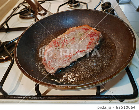 Beef steak in a frying pan 63510664