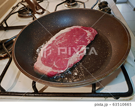Beef steak in a frying pan 63510665