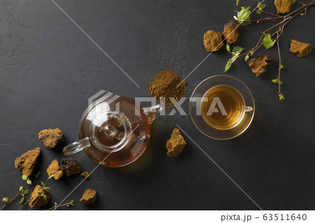 Chaga infusion beverage in cup. Top view. 63511640