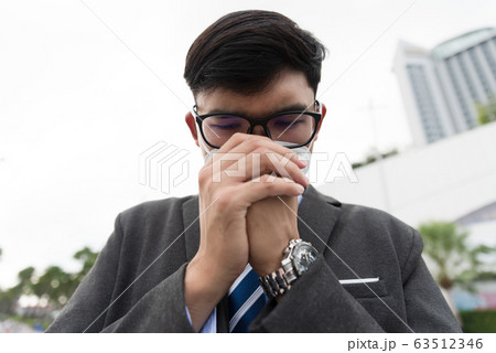 Close up of a businessman in a suit wearing Protective face mask  63512346