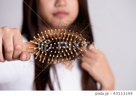 Healthy concept. Woman show her brush with damaged Healthy concept. Woman show her brush with damaged 63513199