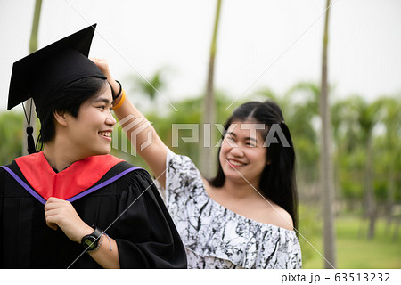 Graduation ceremony. Young female graduate with Graduation ceremony. Young female graduate with 63513232