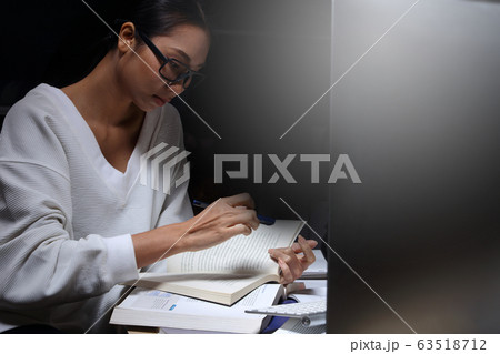 Girl in white shirt reading many textbooks on Girl in white shirt reading many textbooks on 63518712