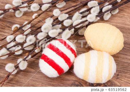 Twigs of willow and colorful Easter eggs 63519562