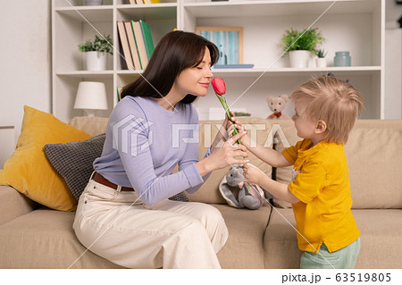 Giving flower to mother Giving flower to mother 63519805