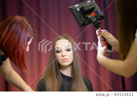 Makeup artists take pictures of the model after their work Makeup artists take pictures of the model after their work 63522611