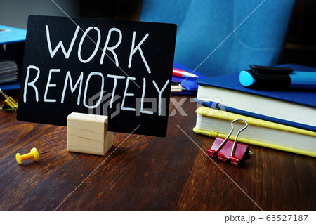 Work remotely sign on the desk about remote job. Work remotely sign on the desk about remote job. 63527187