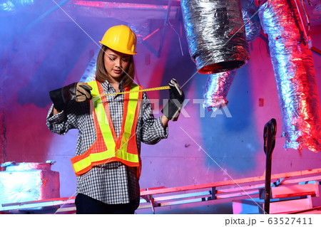 Beautiful Asian Architect Engineer woman in yellow Beautiful Asian Architect Engineer woman in yellow 63527411