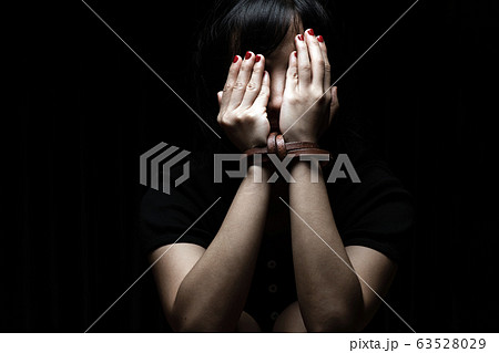 Woman tied up with leather belt in emotional 63528029