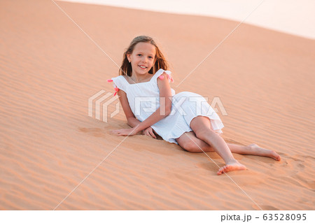 Girl among dunes in desert in United Arab Emirates Girl among dunes in desert in United Arab Emirates 63528095