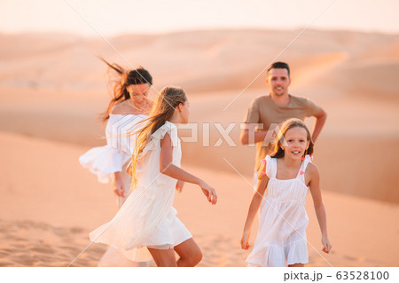 People among dunes in desert in United Arab Emirates People among dunes in desert in United Arab Emirates 63528100