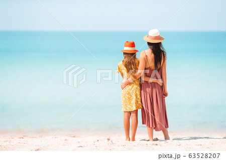 Beautiful mother and daughter at the beach enjoying summer vacation. 63528207