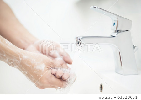 Men are washing their hands every time before eating Men are washing their hands every time before eating 63528651