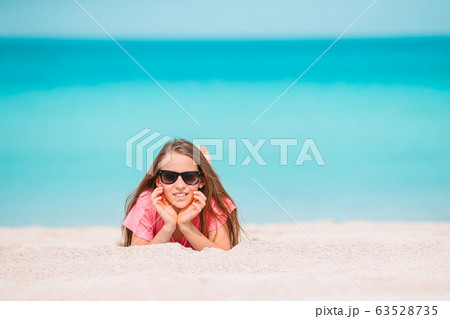 Adorable active little girl at beach during summer vacation 63528735