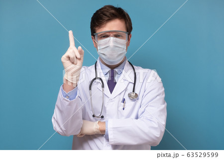 Physician or doctor posing with a face mask 63529599
