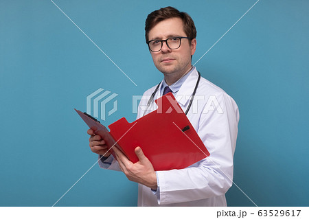 doctor reading some notes trying to make a correct 63529617