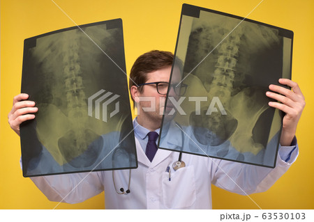 Radiologist man checking xray od spine and Radiologist man checking xray od spine and 63530103