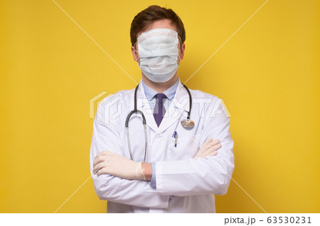 A portrait of a physician posing with a face mask A portrait of a physician posing with a face mask 63530231