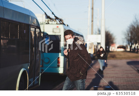 People wearing surgical mask standing at the bus People wearing surgical mask standing at the bus 63530518