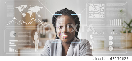 Face scanning of African American businesswoman in defocused office with double exposure of information on screen 63530628