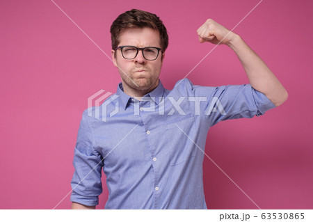 Attractive young man in glasses and blue shirt Attractive young man in glasses and blue shirt 63530865