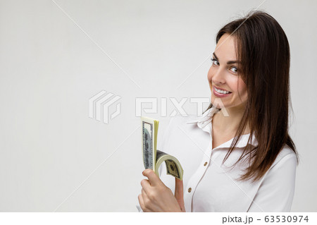 smiling woman holding money smiling woman holding money 63530974