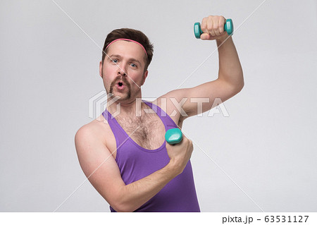 Satisfied young strength retro man lifting 63531127