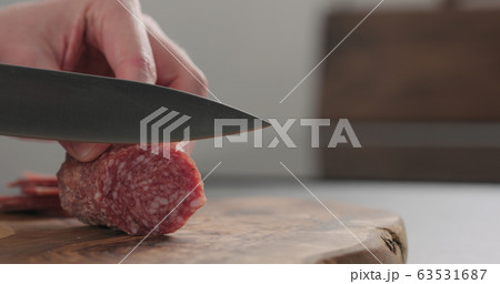 slicing italian salame on wood board with copy space slicing italian salame on wood board with copy space 63531687