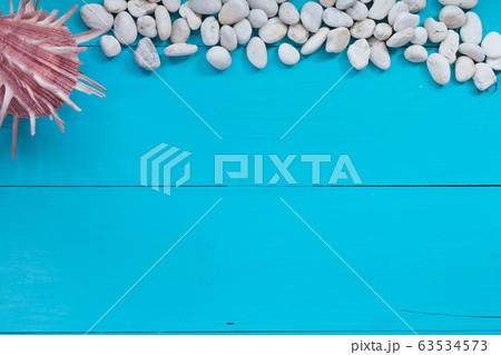 Seashells and pebble on wood background. Top view with copy space 63534573