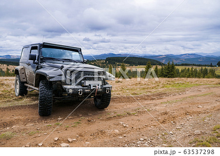 Black jeep parked by the road with picturesque Black jeep parked by the road with picturesque 63537298