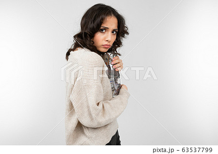 girl hugs her piggy bank tightly so that it is not taken away on a gray background girl hugs her piggy bank tightly so that it is not taken away on a gray background 63537799