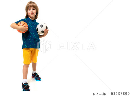 sport winner boy holding a soccer and basketball ball in his hands on a white background with copy 63537899